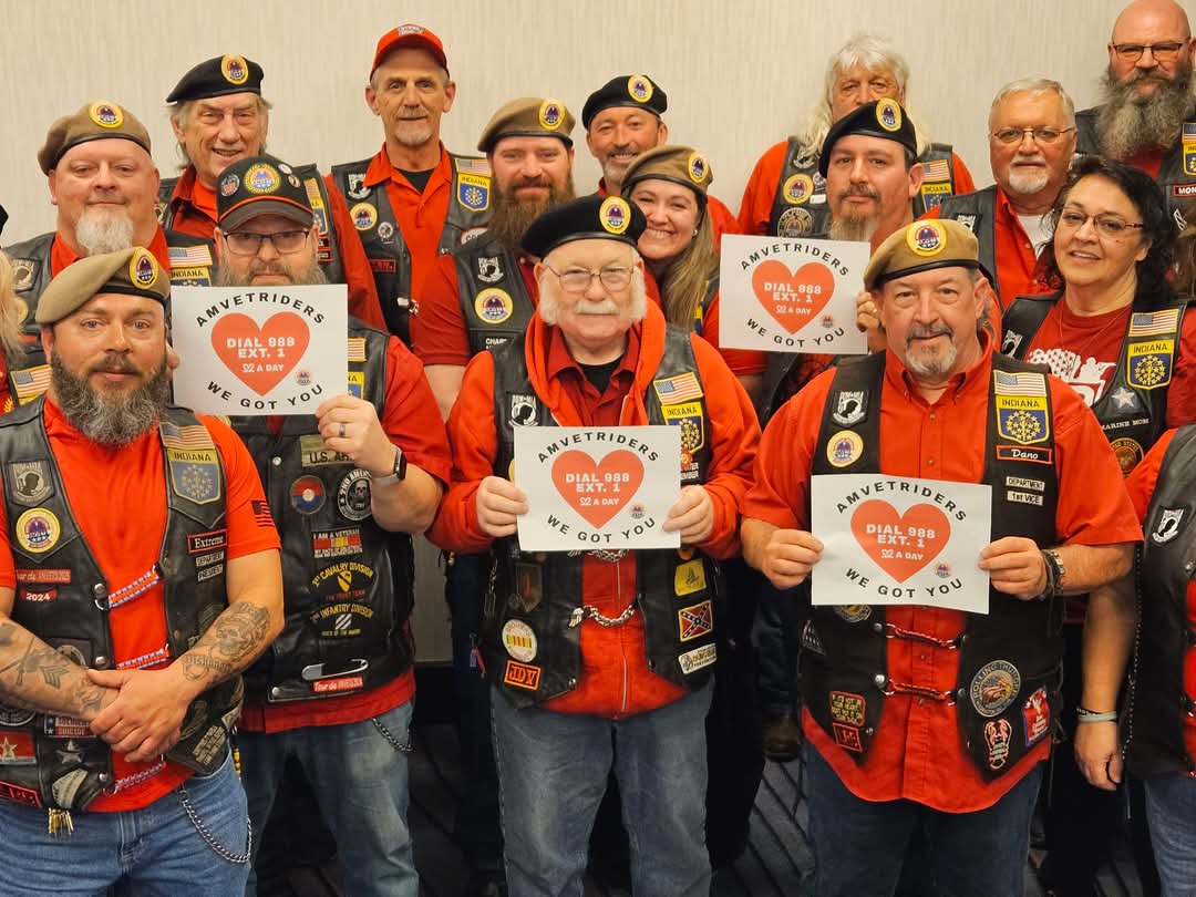 AMVETS Riders with their WE GOT YOU T-Shirts on and holding up heart signs with WE GOT YOU on them for Veteran's Suicide Prevention